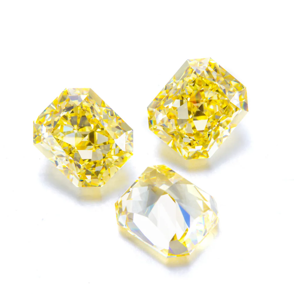 Yellow and champagne lab-grown colored gemstones in mixed cuts on a white background