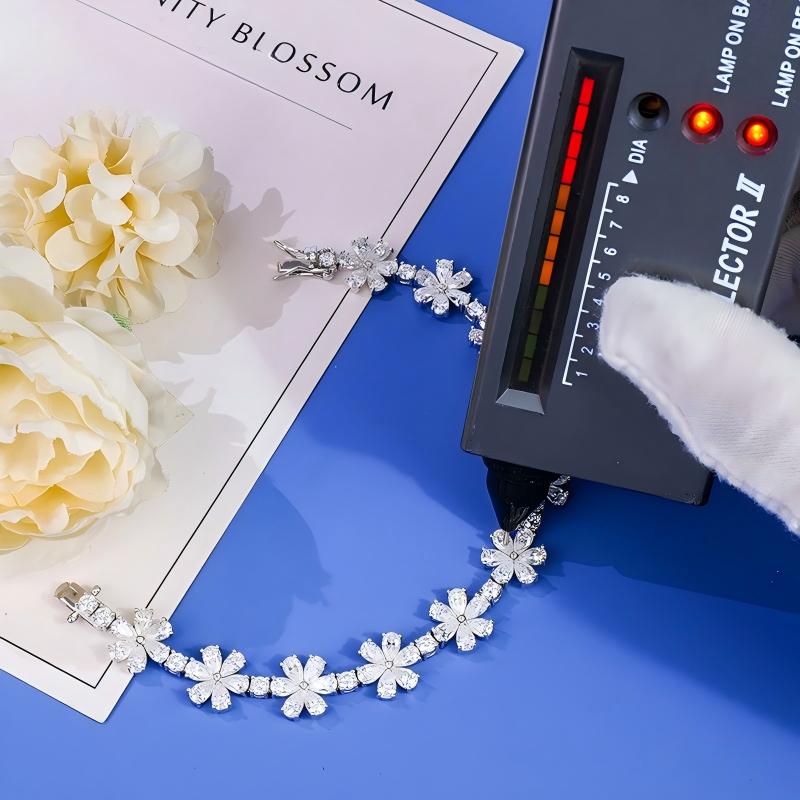 Finished colorless-stone bracelet being checked with a diamond selector during quality control